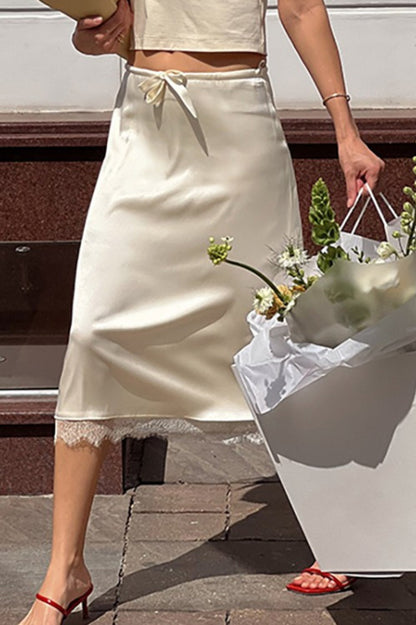 Falda midi elegante con ribete de encaje y lazo en la cintura
