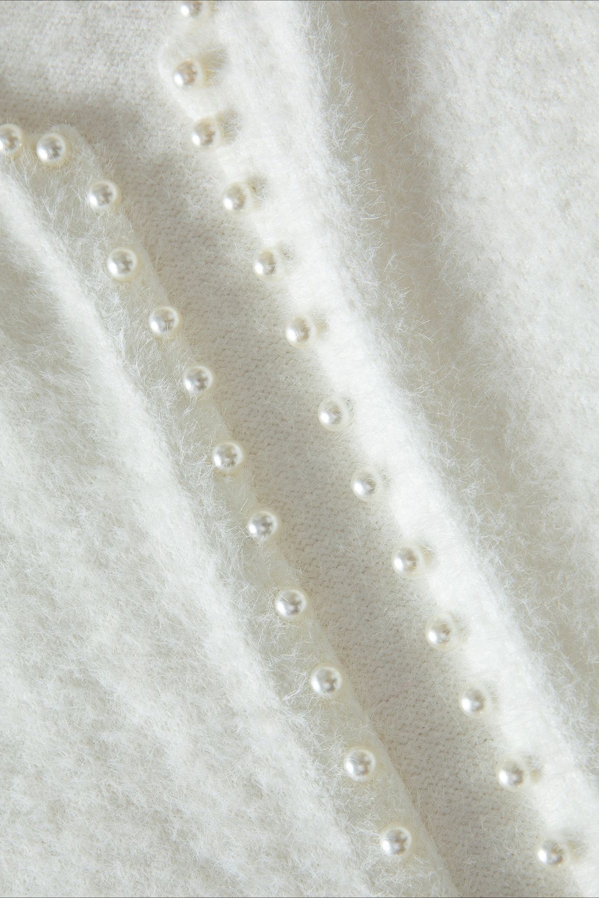 Elegante suéter de punto con cuello de pico y perlas