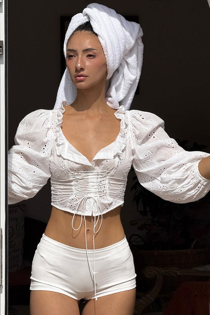 Blusa de algodón con cuello en V, mangas abullonadas y lazo
